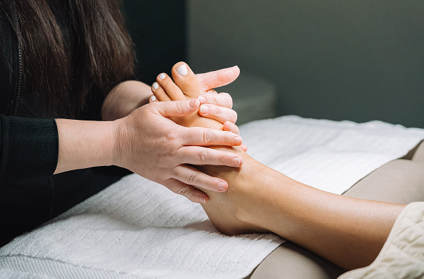 a person massaging a foot