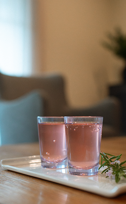 a couple of glasses of pink liquid