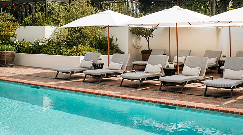 a pool with chairs and umbrellas