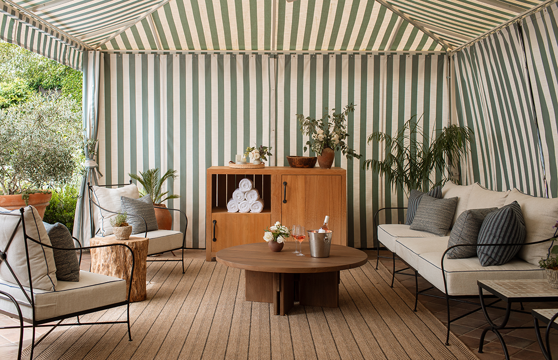 a room with a striped tent and a table and chairs