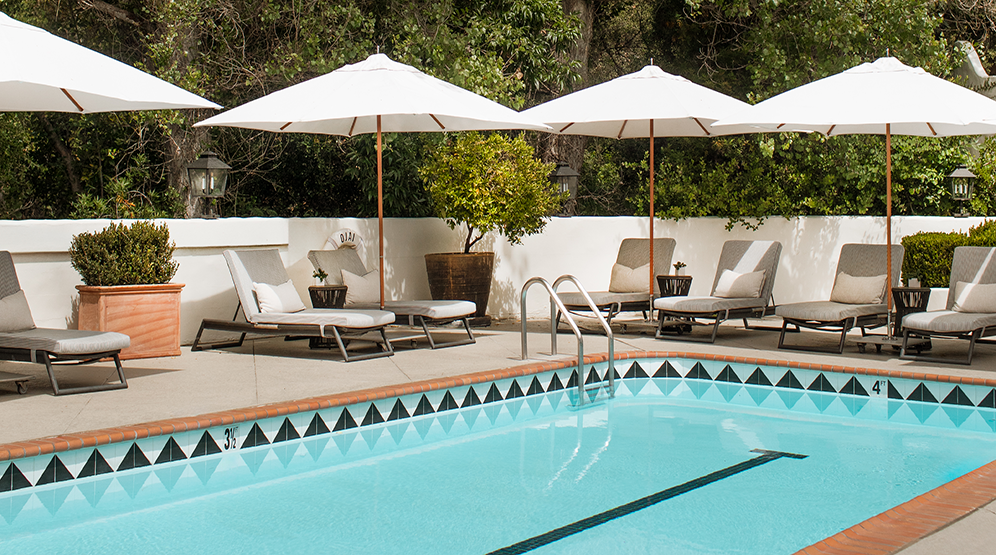 a pool with umbrellas and chairs