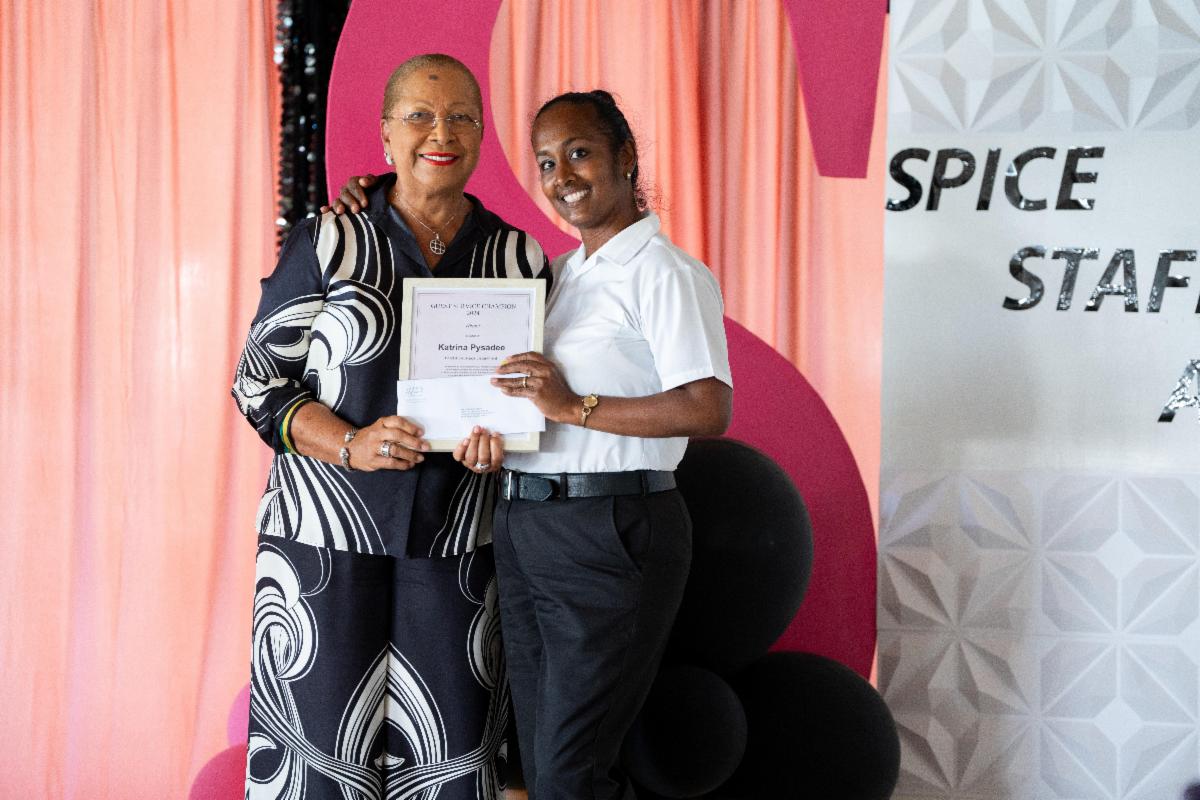 two women holding a certificate
