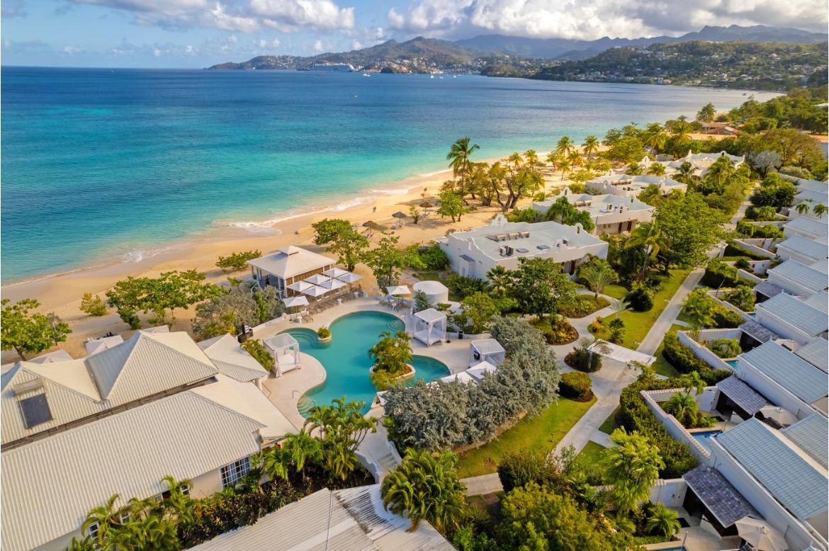 a beach with houses and a pool