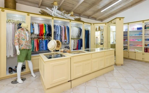 a store with a mannequin in front of a display of clothes
