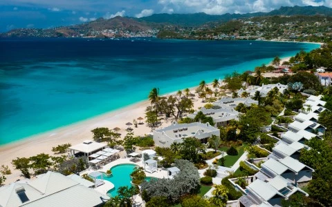 a beach with buildings and a pool