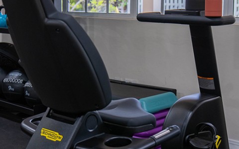 a exercise bike with a screen and a bottle of water