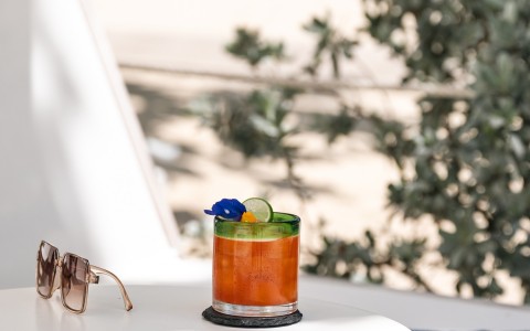 a glass with a drink on a table