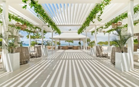 a covered patio with white furniture