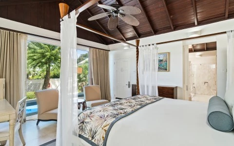 a bedroom with a ceiling fan and a bed