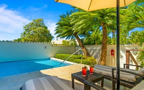 a pool with a table and chairs