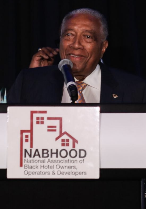 view of man giving a speech at a conference