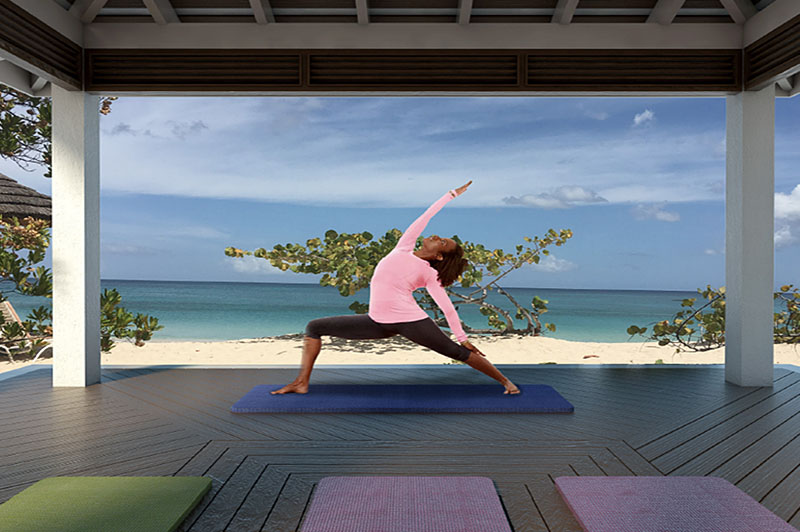 a woman practicing yoga beachside