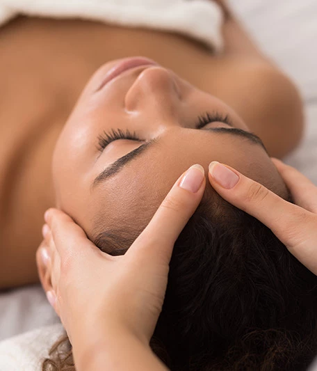 a woman receiving a facial massage