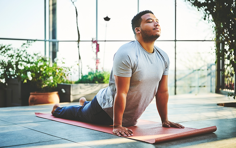 a man doing yoga on a mat