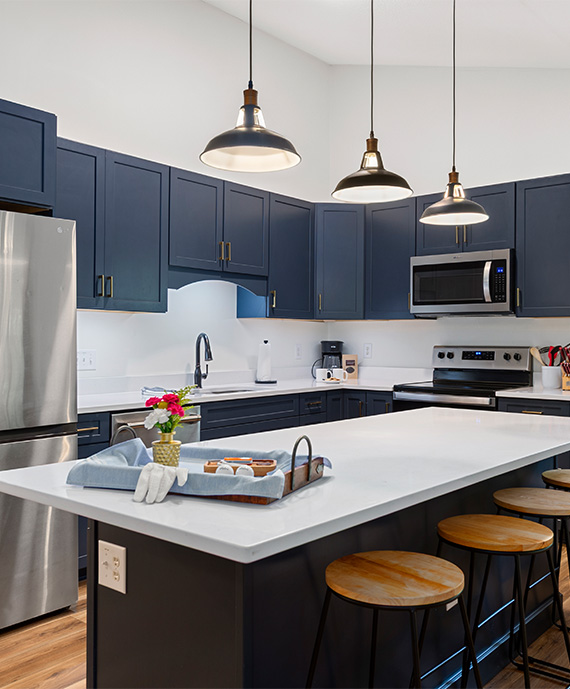 a kitchen with a large island and stools