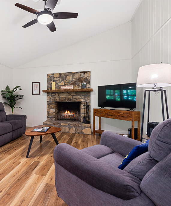 a living room with a fireplace and couches