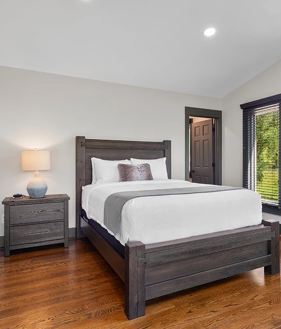 a bedroom with a bed and a lamp