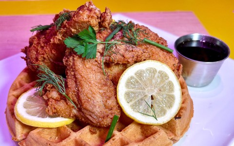 a plate of food with lemon slices and sauce