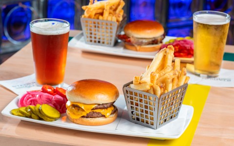 a plate of burgers and fries on a table