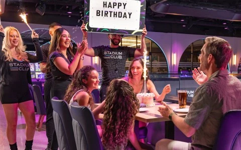 a group of people around a table with a sign