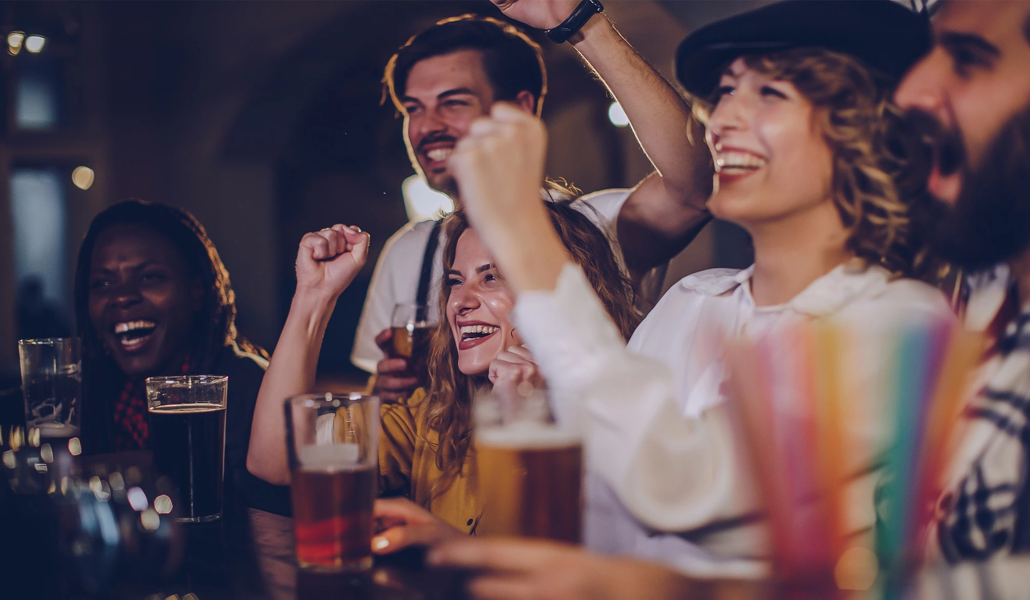 a group of people with their hands up and smiling