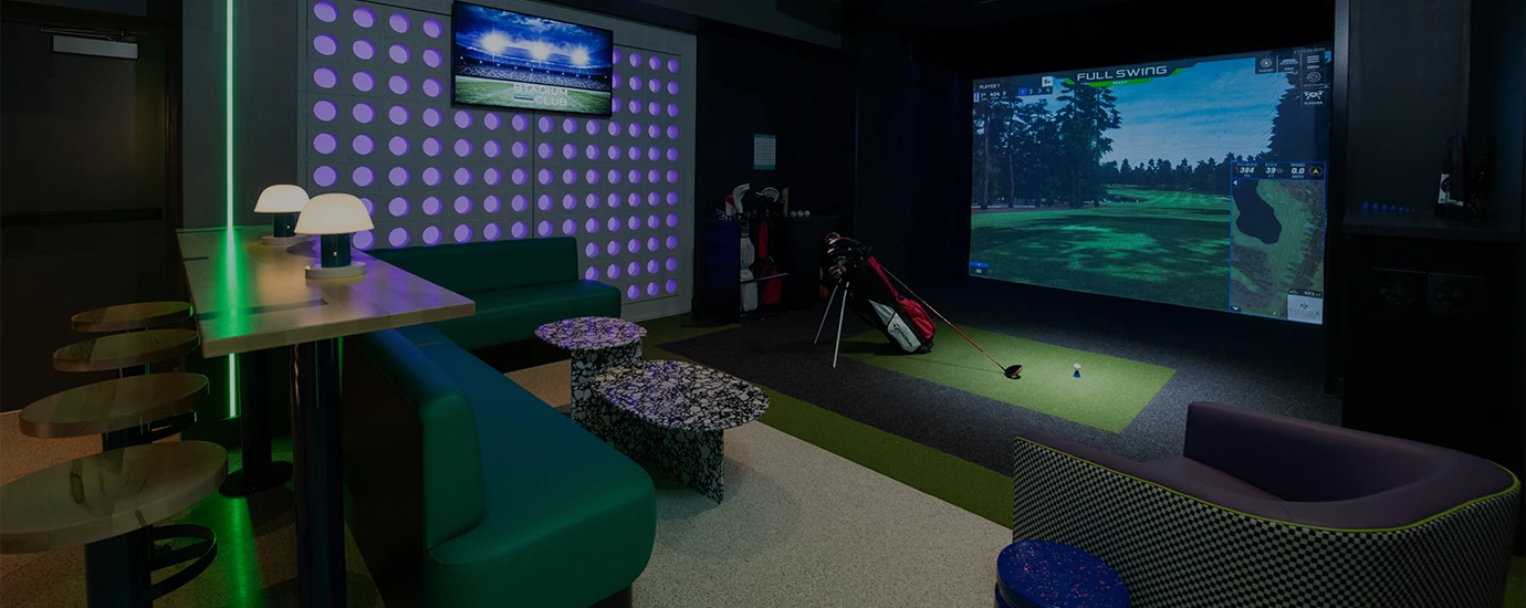 a room with a golf club and a large screen