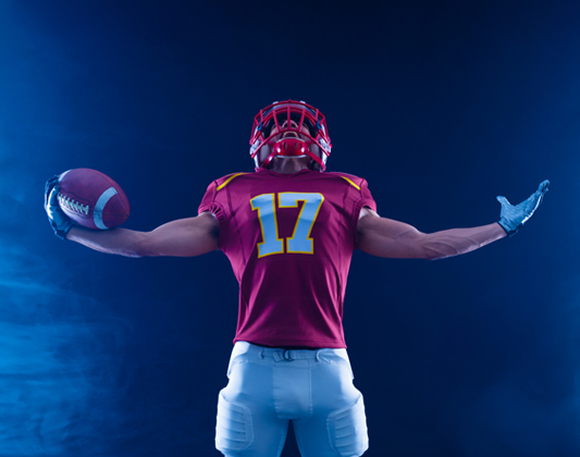 a football player holding a football