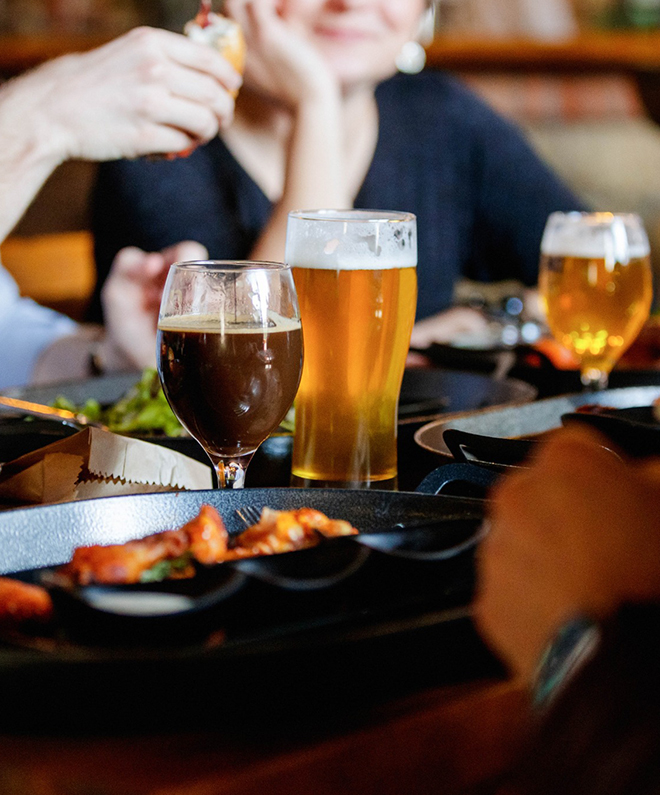 a group of people sitting at a table with drinks