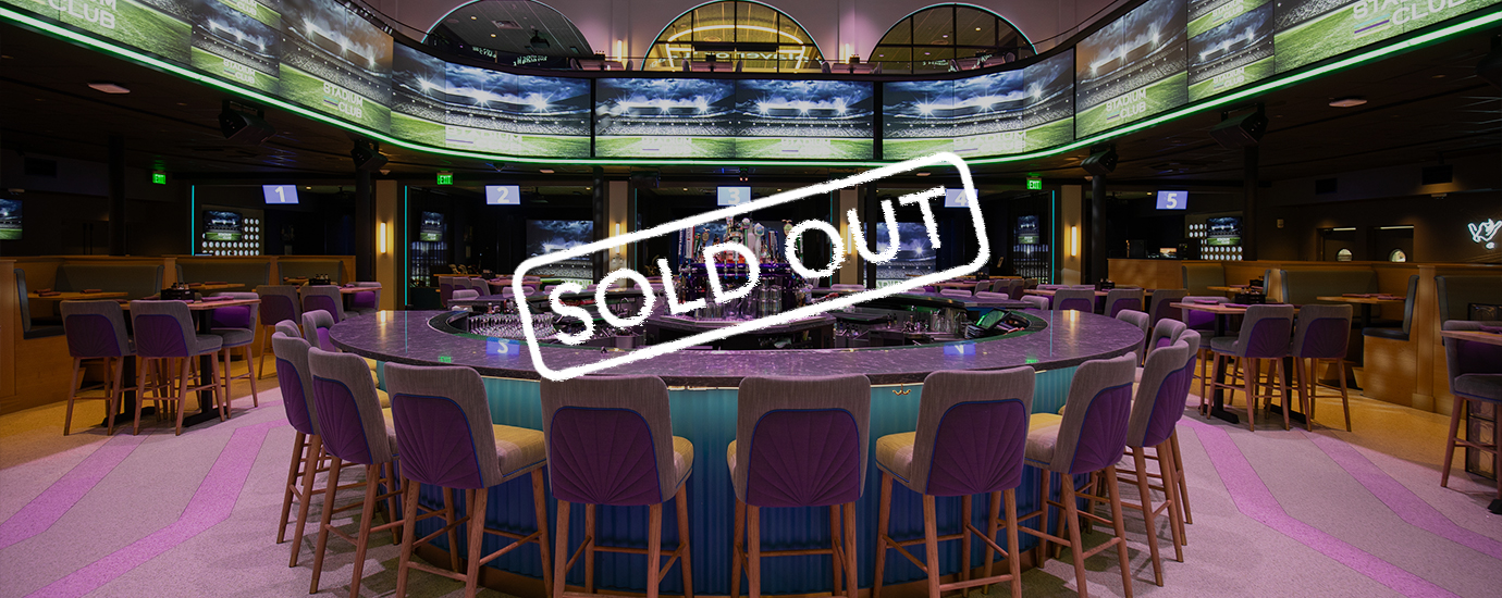 a bar with chairs and a sign