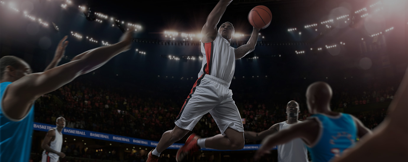 a basketball player in mid air with a ball in the air