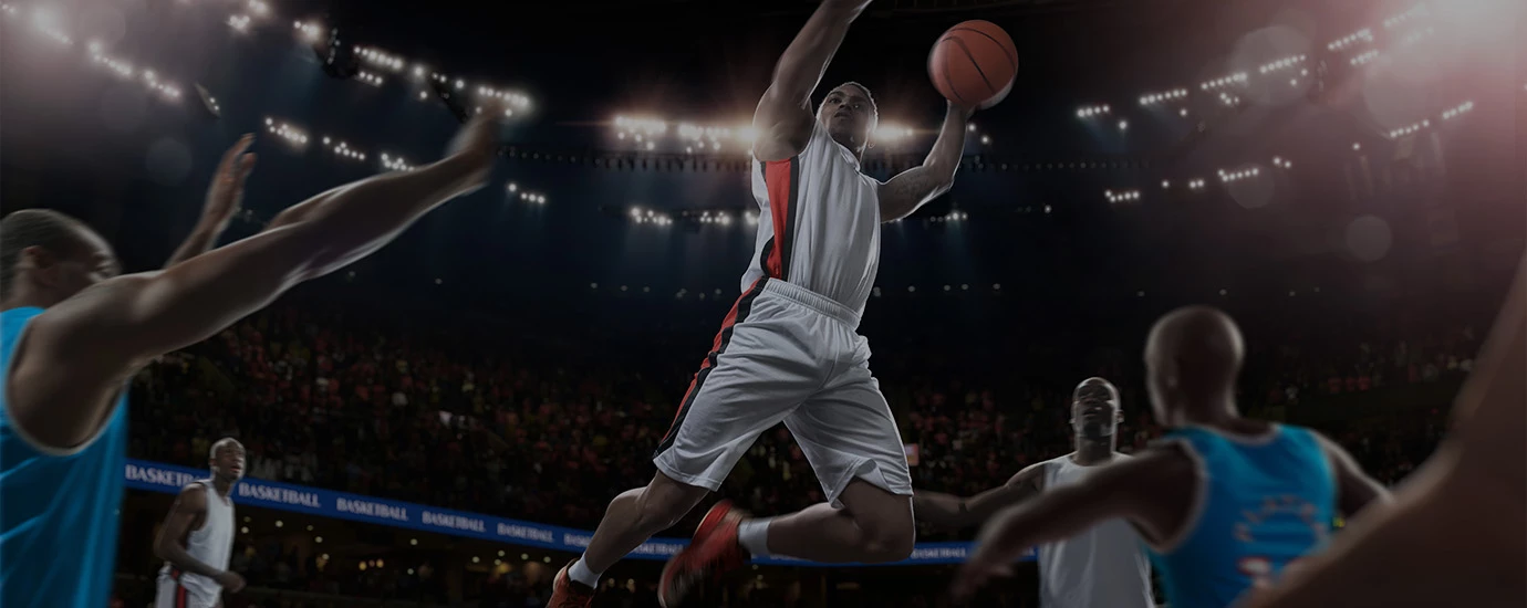 a basketball player in mid air with a ball in the air