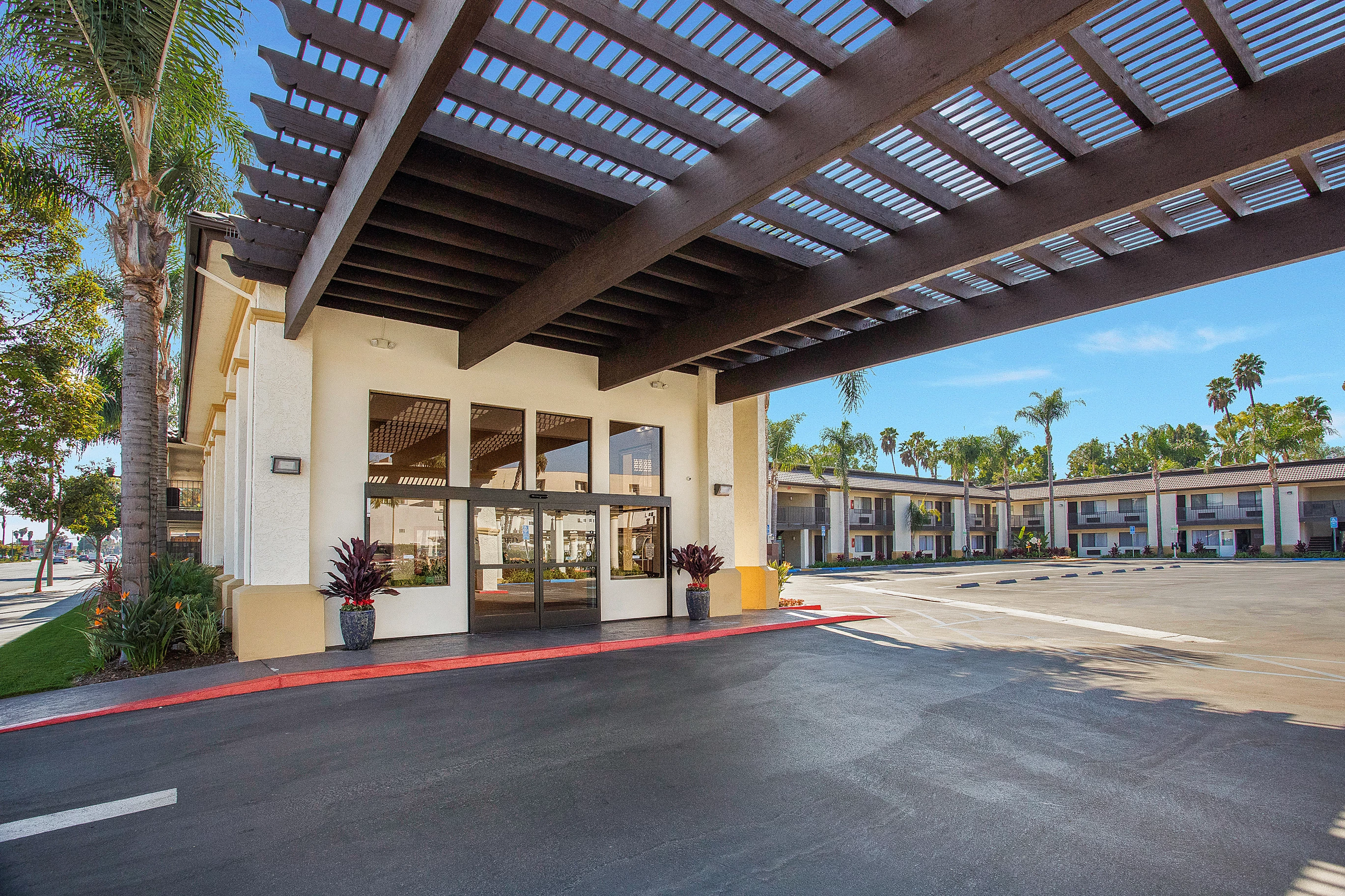 a building with a roof over a parking lot