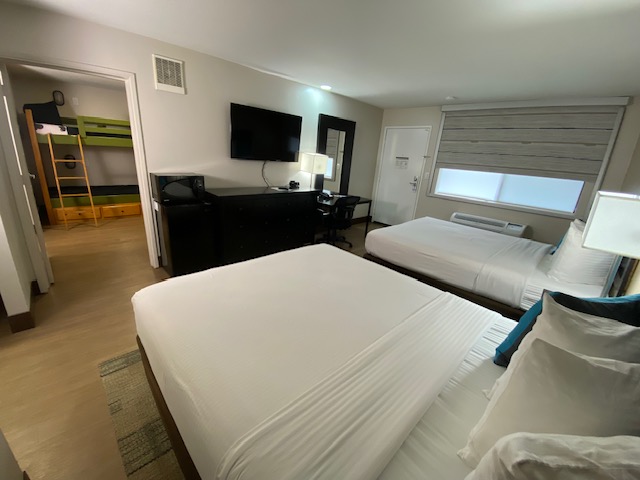 a room with two beds and a tv