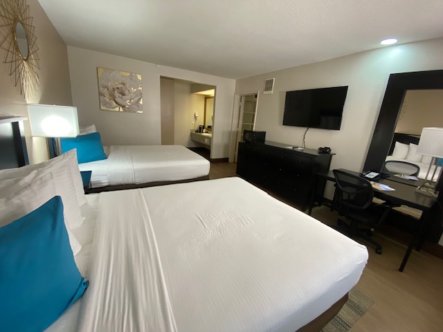 a room with two beds and a television