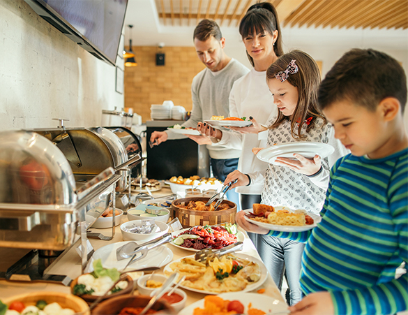 family serving breakfast at buffet