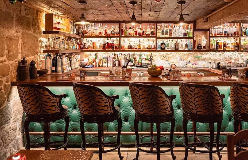 a bar with chairs and a counter