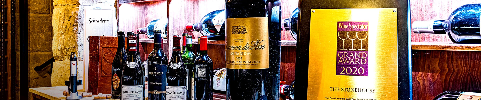 close up of the spectator grand award 2020 with wine bottles in the background