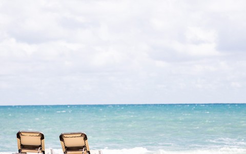 chairs on a beach by the ocean