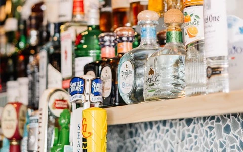 a shelf with bottles of alcohol