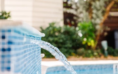 a water pouring out of a pool