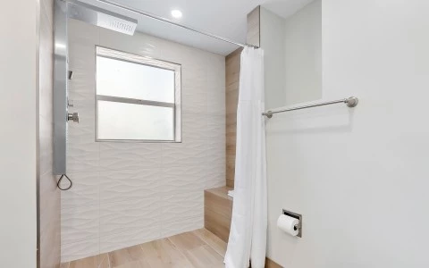 a white shower curtain in a bathroom