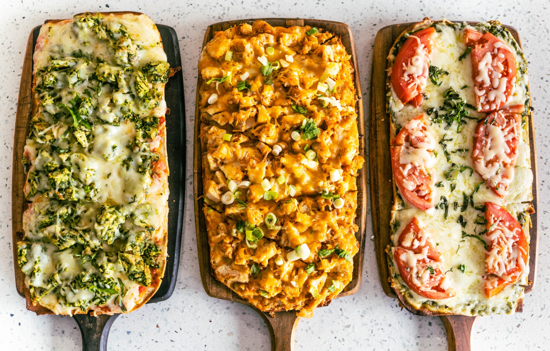 a group of pizzas on a table