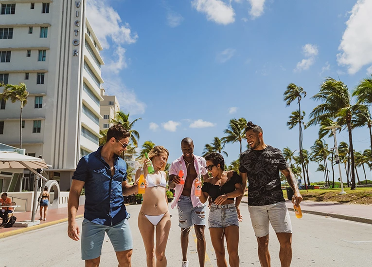 group of friends walking down the street near the beach