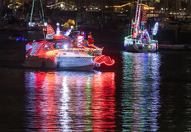 a group of boats with lights on the water