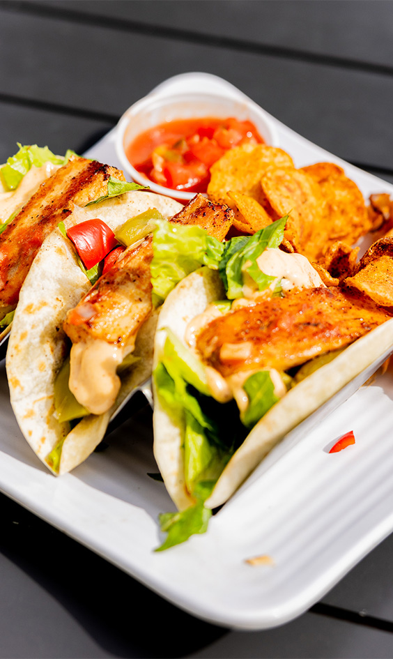 a plate of tacos and salsa