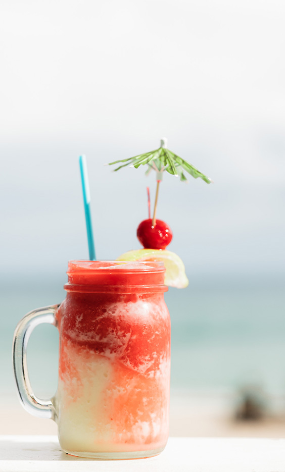 a glass with a drink and a straw
