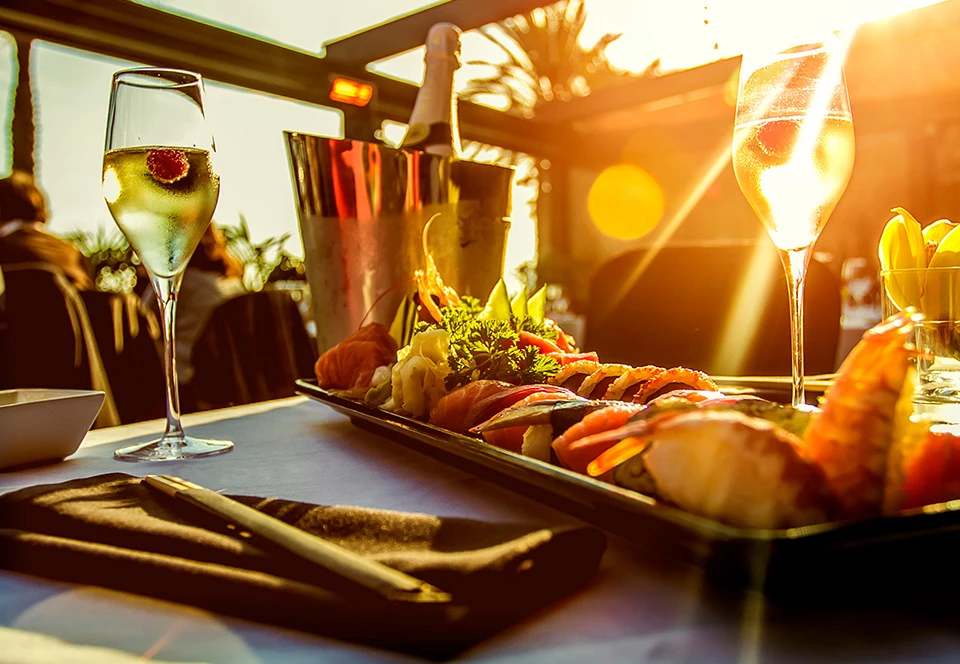 a table with food and wine glasses
