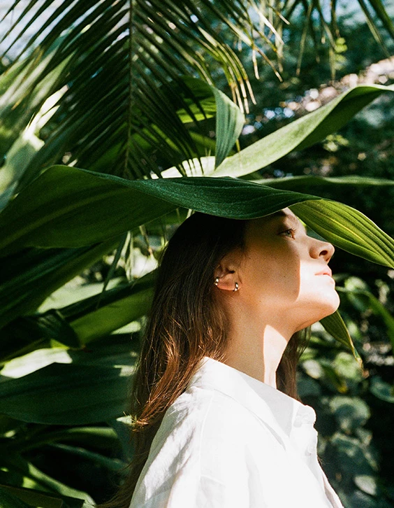 a person with leaves over her head