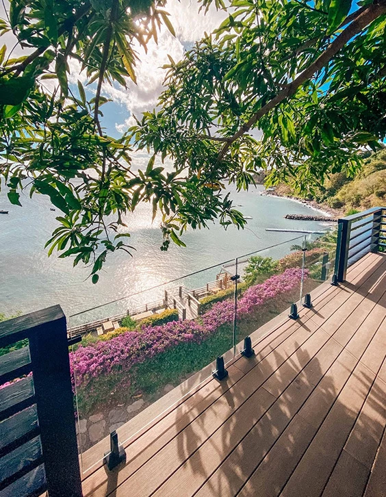 a wooden walkway next to a body of water