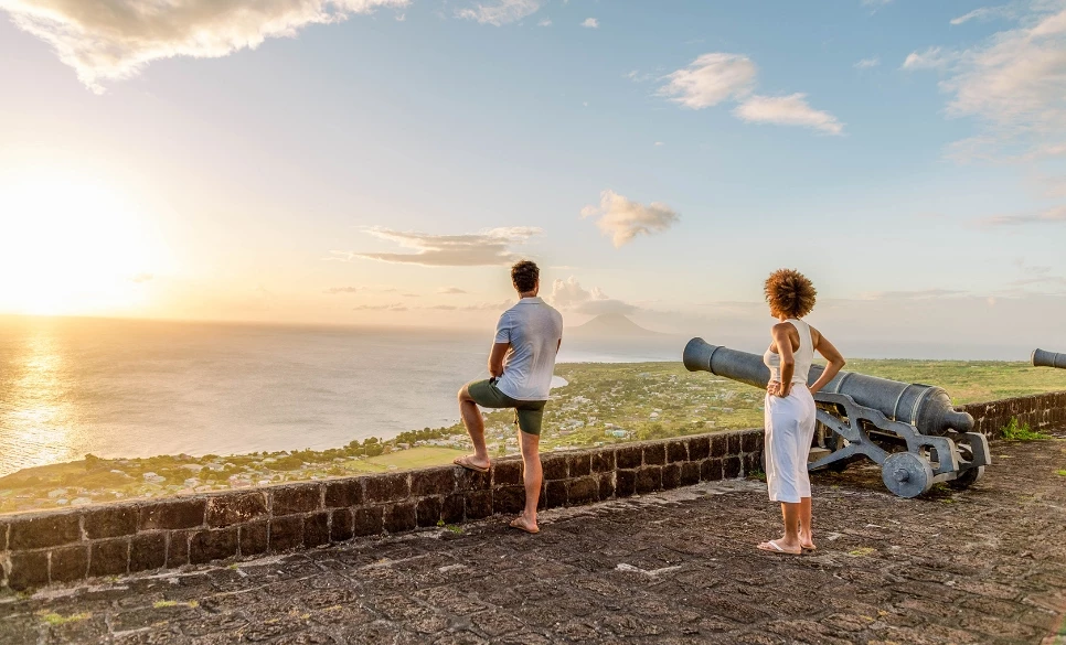 a man and woman looking at a cannon